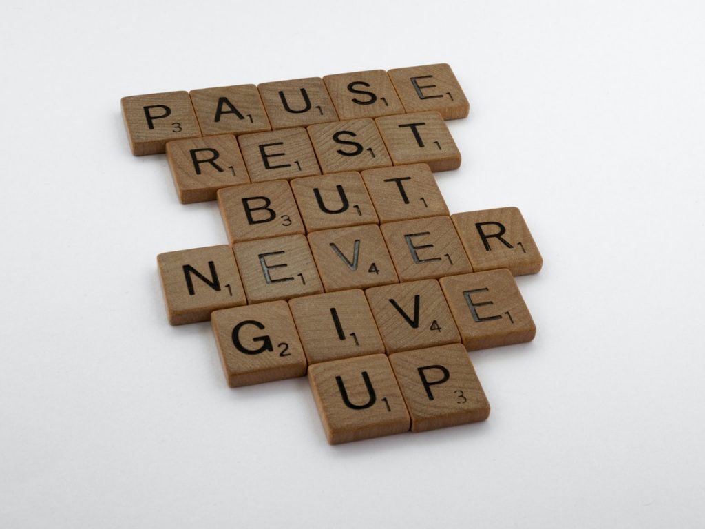 Image of scrabble blocks saying Pause, rest, but never give up